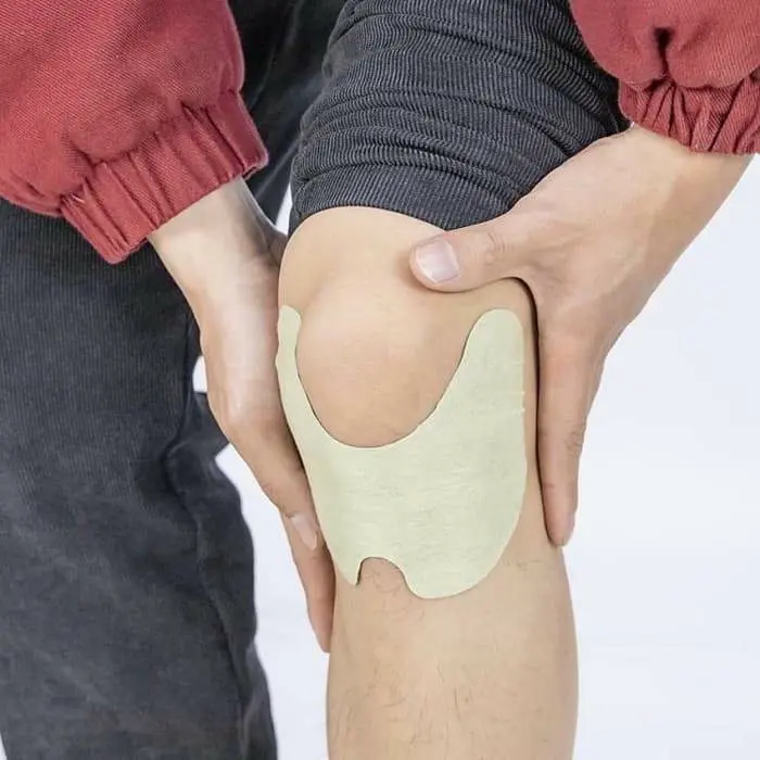 Applying a herbal knee patch for everyday knee relief