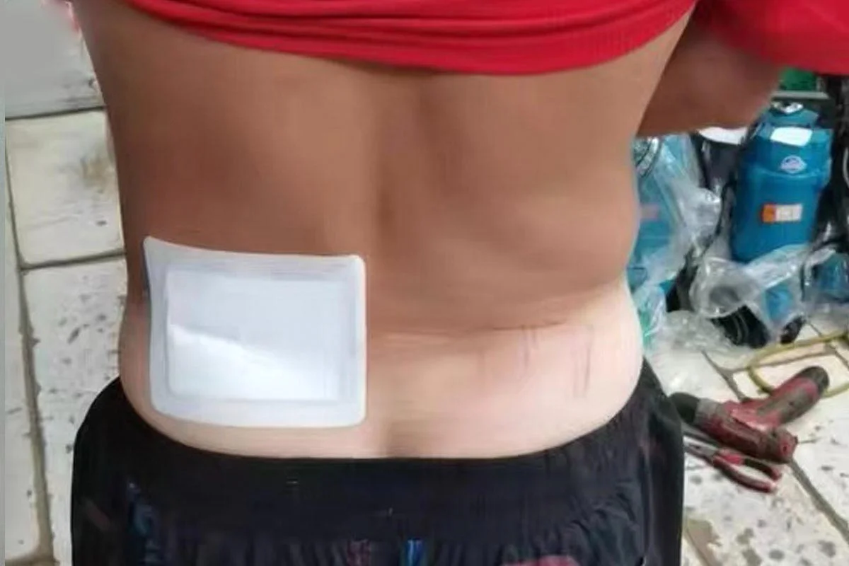 Man with back pain patch